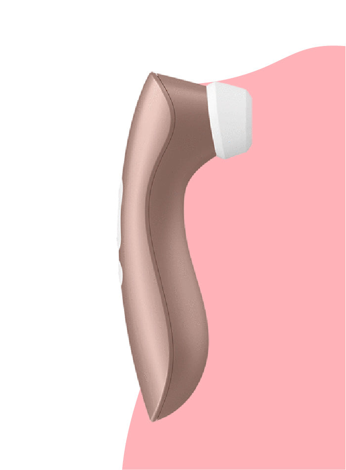 A side view of the Satisfyer PRO 2+ clitoris stimulator in front of a light pink and white curvy background